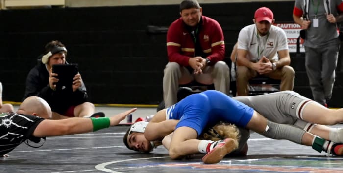 Roman Lermer from Tampa Jesuit takes down Elijah Lowe from Lake Gibson during a 120-pound semifinals match on Saturday at the Knockout Christmas Classic at Silver Spurs Arena in Kissimmee.